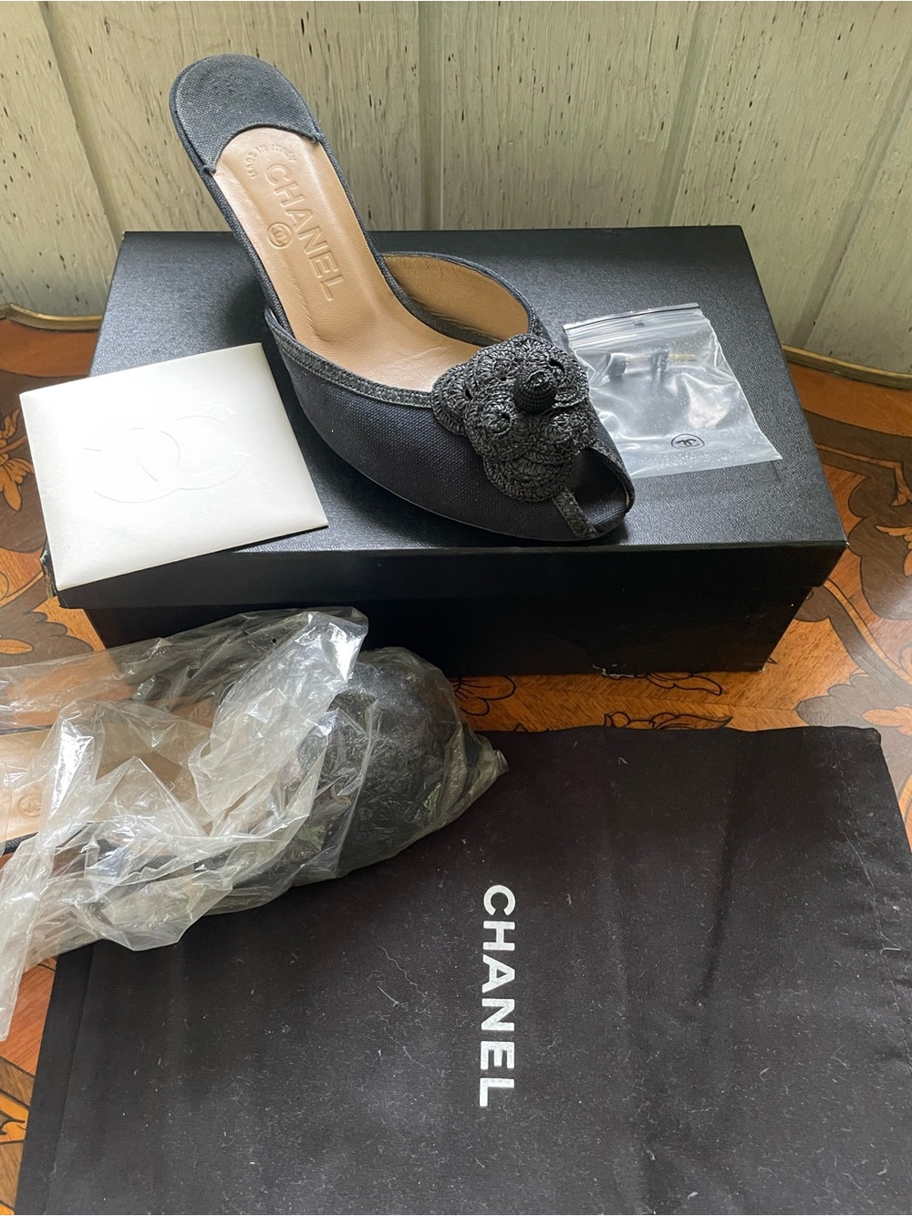 CHANEL Black Open-Toe Mule with Camellia Crochet Accent